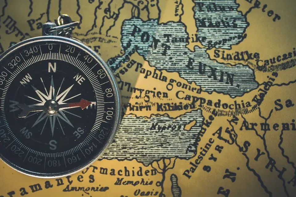 A magnetic compass lying on an antique map of the Black Sea region