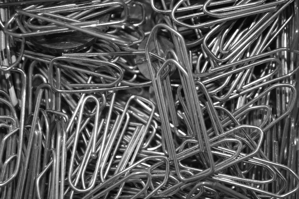 A tangle of silver paper clips filling the frame